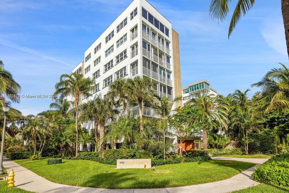 Front view of a modern multi-story building with large windows and balconies.