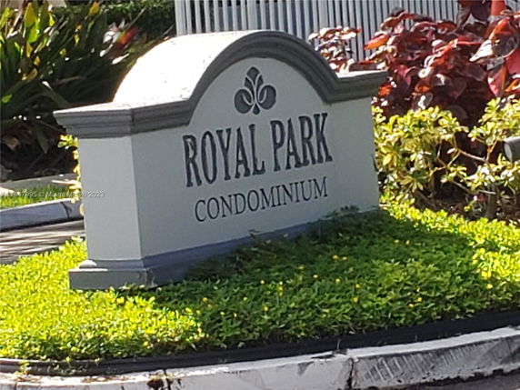 Sign for Royal Park Condominium surrounded by greenery.