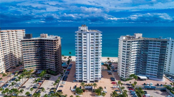 View of beachfront high-rise residential buildings with ocean in the background.