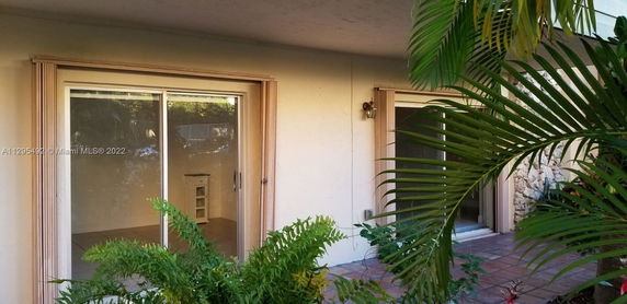 View from an outdoor area showing large glass sliding doors leading into a building.