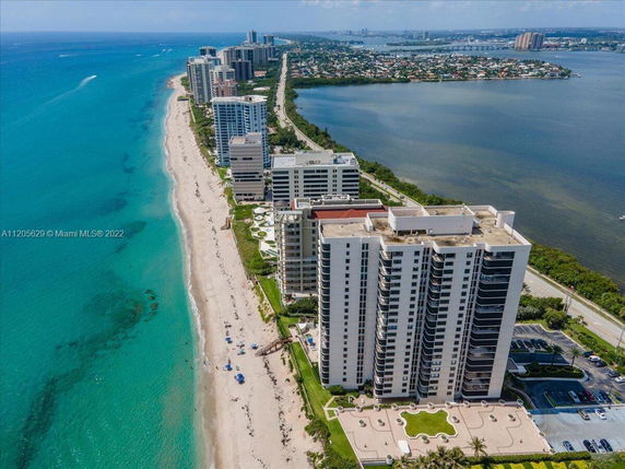 Panoramic view of beachfront high-rise buildings by the ocean.
