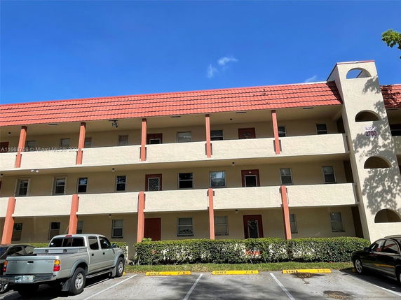 Front view of a multi-story apartment building with balconies.