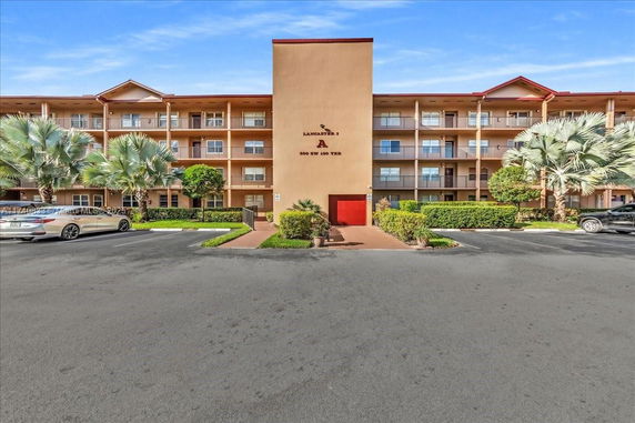 Front view of a multi-story residential building with balconies.