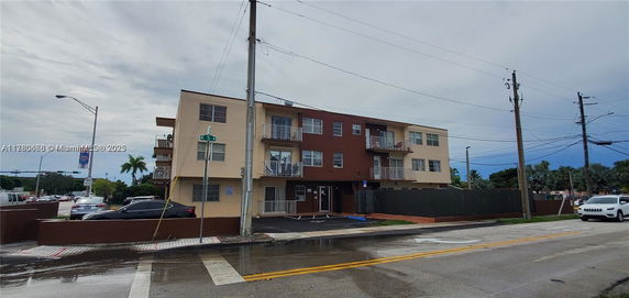 Front view of a three-story residential building with balconies.