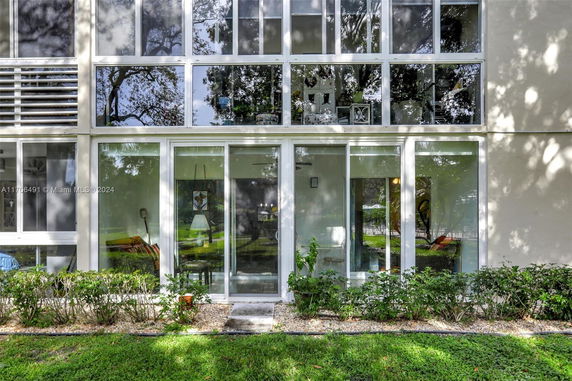 Front view of a modern building with large glass windows.