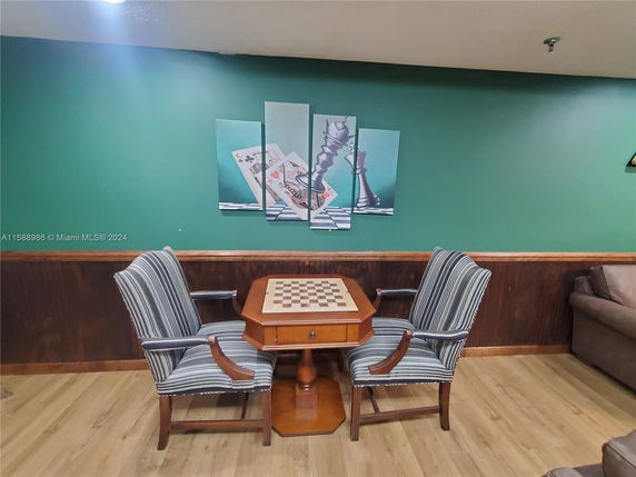 Indoor recreation area with a chess table and chairs.