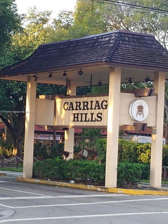 Front view of entrance sign structure for Carriag Hills.