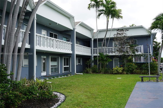 Front view of a two-story residential building with balconies.