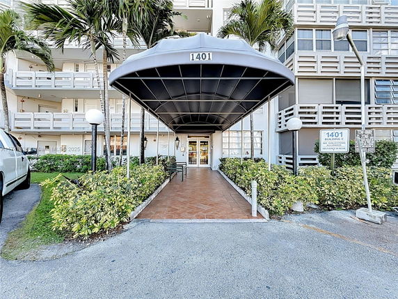 Front view of a multi-story building with a covered entrance.