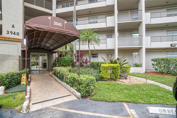Front view of a multi-story building entrance with a covered walkway.