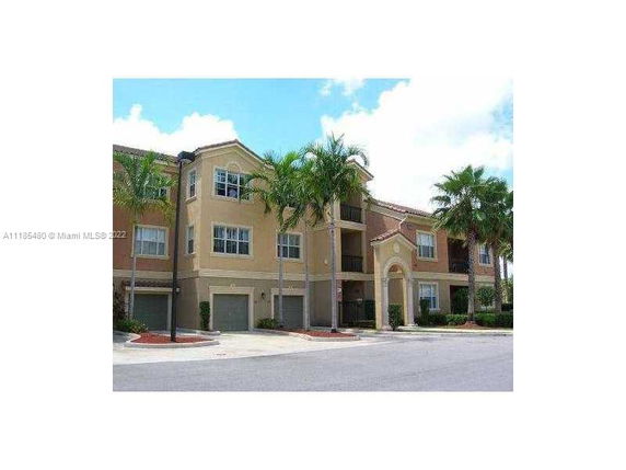 Front view of a multi-story residential building with attached garages.