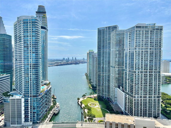 Panoramic view of high-rise buildings next to a waterway.