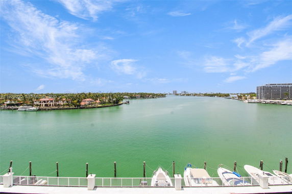 Wide view of a waterway with boats and distant buildings.