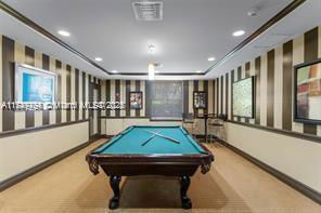 Room with a pool table in an indoor recreational area.
