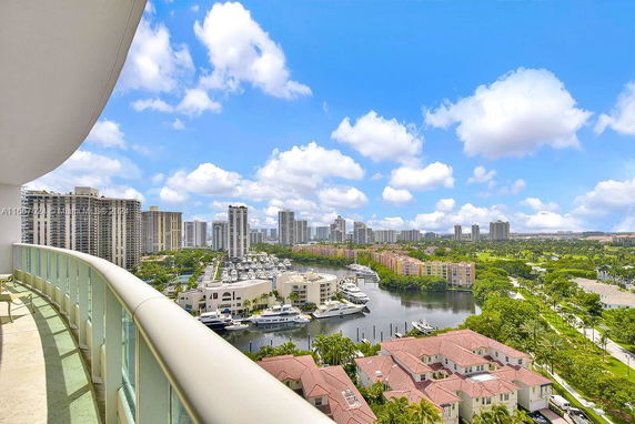 Panoramic view of a cityscape with high-rise buildings and a marina.