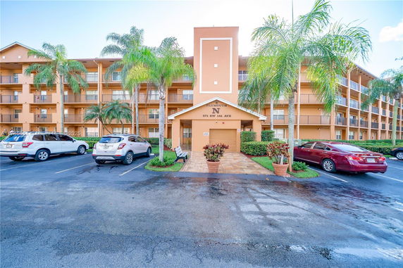 Front view of a multi-story residential building with balconies.