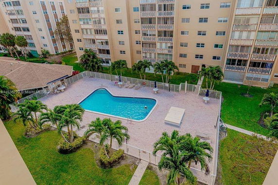 Outdoor swimming pool area surrounded by apartment buildings.