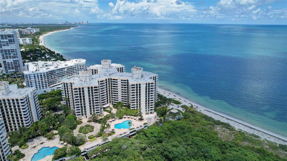 Wide angle view of beachfront high-rise buildings with swimming pools.