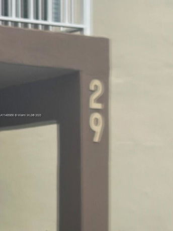 Partial view of a building with the number 29 displayed on its exterior.