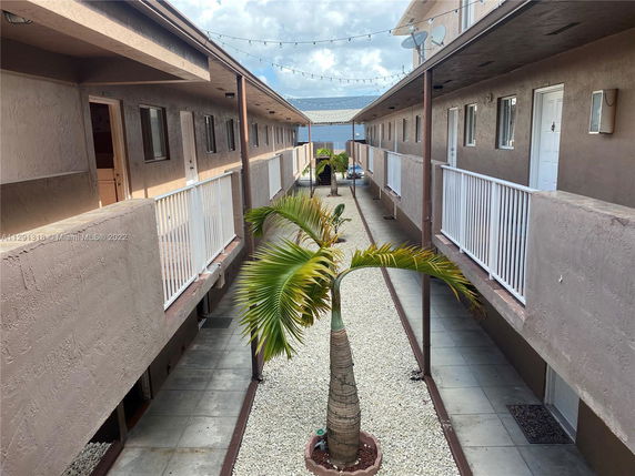 View of the inner courtyard between two buildings with railing balconies.