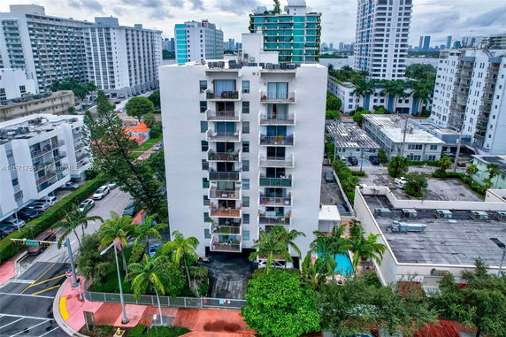 Front view of a multi-story residential building with balconies.