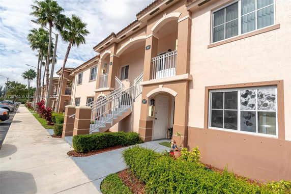 Front view of a two-story apartment building with external staircases.