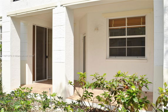 Partial front view of a building with covered porch and window.