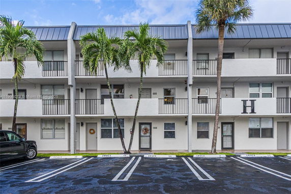Front view of a multi-story residential building with balconies.