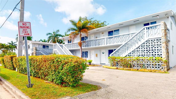Front view of a two-story apartment building with exterior stairs.