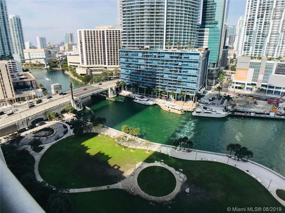 View of surrounding high-rise buildings and a waterway.