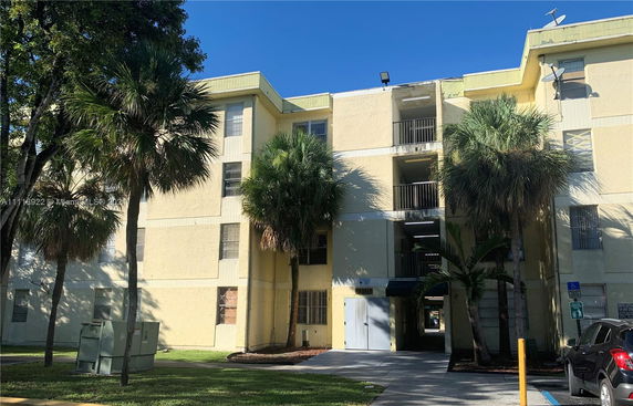 Front view of a multi-story residential building with balconies.