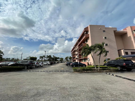 Front view of a multi-story residential building with balconies.