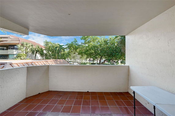 View of surrounding area from a covered outdoor balcony.