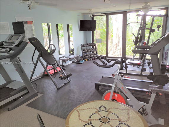 Indoor gym area with exercise equipment such as treadmills, weights, and a stationary bike.