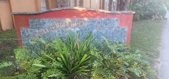 Front view of a building with a prominent sign.