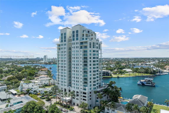 Front view of a high-rise residential building near a body of water.