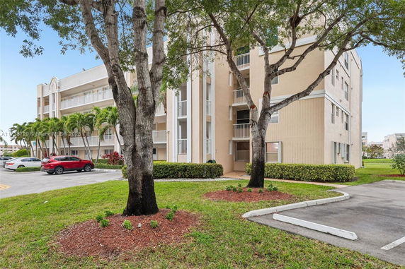 Front view of a multi-story residential building with balconies.