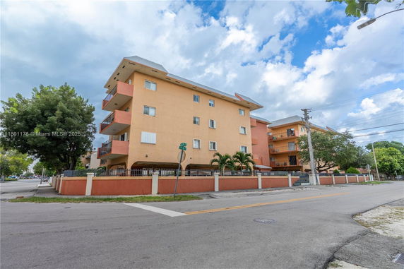 Front view of a multi-story residential building with balconies.