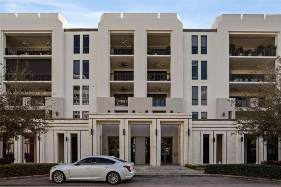 Front view of a multi-story building with balconies and a modern facade.