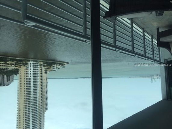 View from a building showcasing nearby skyscrapers and waterfront.
