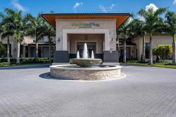 Front view of a building with a fountain in the entrance area.