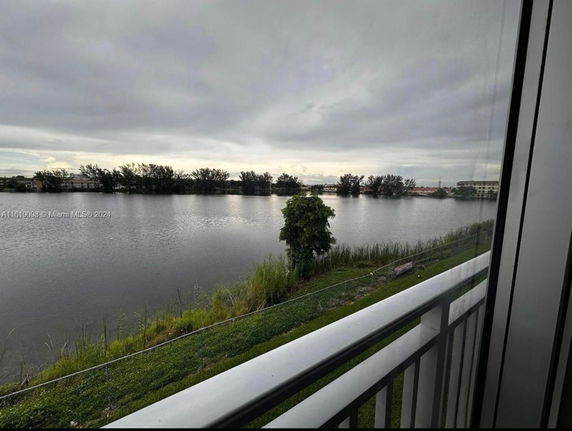 View from a building overlooking a body of water and trees.