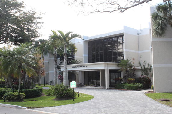 Front view of a multi-story building with large windows.