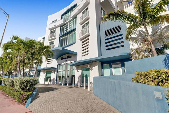 Front view of a modern multi-story building with blue and white exterior.