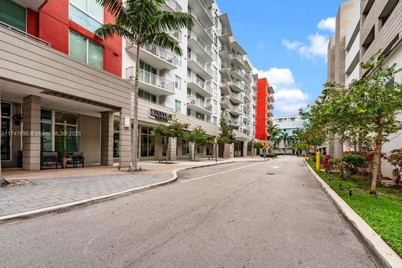 Front view of multi-story residential buildings along a street.