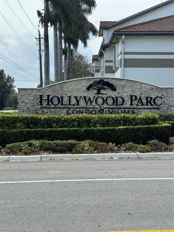 Front view of a large multi-story residential condominium complex.