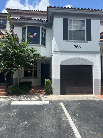 Front view of a two-story house with a garage.