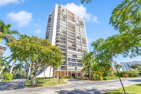 Front view of a high-rise apartment building with multiple balconies.