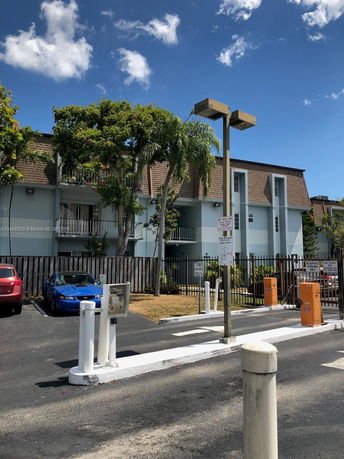 Parking area with access control in front of a building.