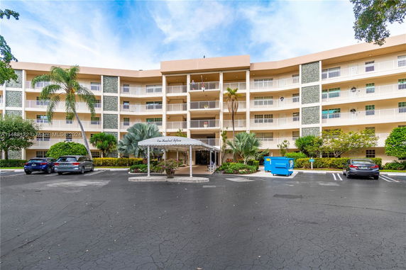 Front view of a multi-story residential building with balconies.